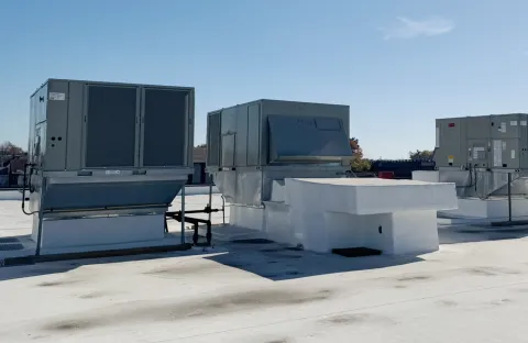 Two large HVAC units on a flat commercial roof.